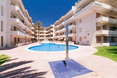a swimming pool in front of a building at Apartamentos Colibri in Cambrils