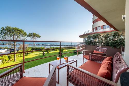 a balcony with benches and a view of the ocean at Grand Hotel Torre Fara in Chiavari