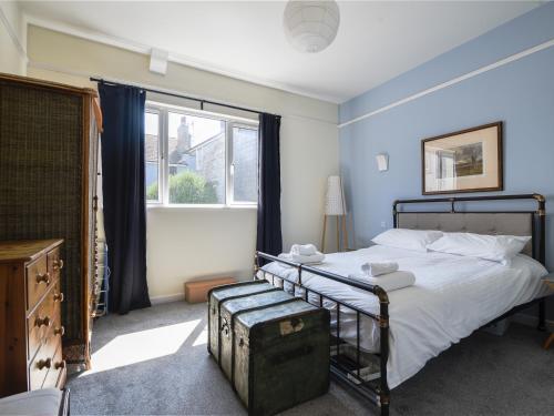 a bedroom with a bed and a large window at Bahari in Lyme Regis