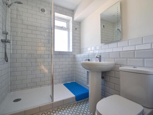 a bathroom with a shower sink and a toilet at Bahari in Lyme Regis