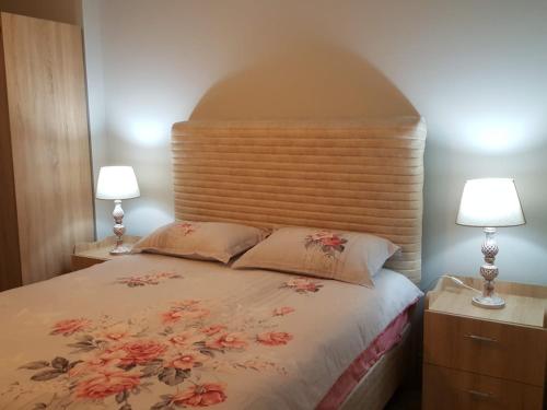 a bedroom with a large bed with two lamps at Tourist rent Apartment in Istanbul