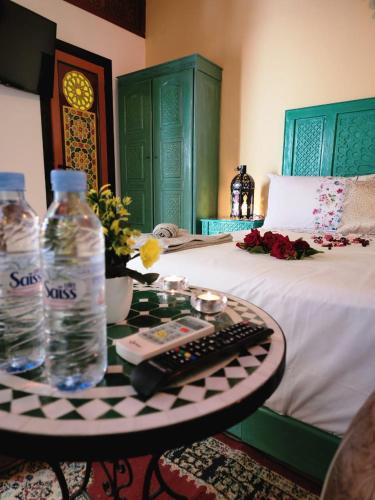 a table with a computer keyboard and a bottle of water at Riad Dar Kassim in Fès