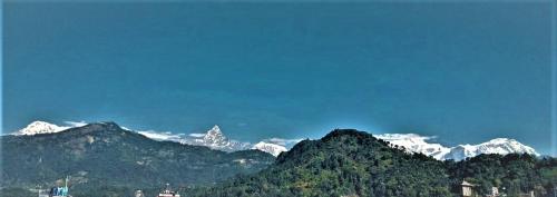 a view of a mountain range with snow capped mountains at Hotel Mala Pokhara in Pokhara