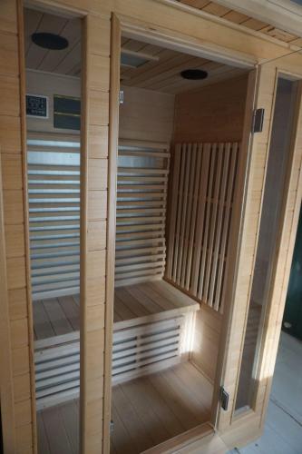 a wooden sauna with a glass door in a room at Notte Rosa Suites & Relax in Fornovo di Taro