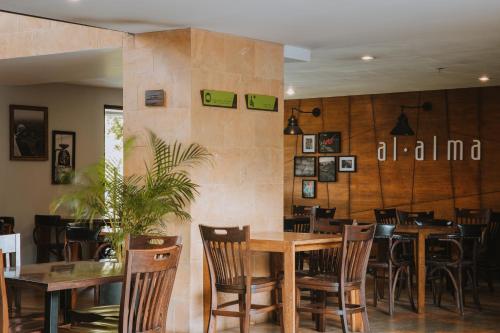 a dining room with wooden tables and chairs at Travelers Rio Verde Living Suites in Rionegro