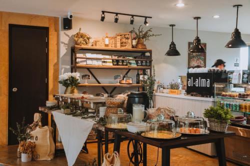 a bakery with a table with food on it at Travelers Rio Verde Living Suites in Rionegro