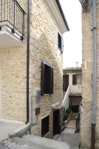 a brick building with a staircase next to it at Casa Vacanza Orto dei Preti in Collepardo