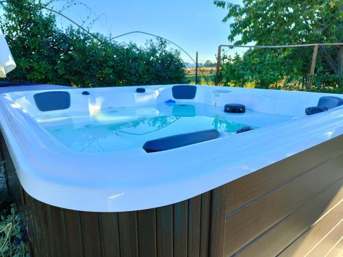 a bath tub sitting on top of a wooden fence at B&B Villa Letizia in San Vito Rimini