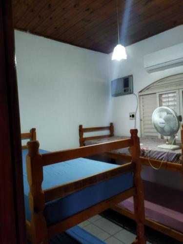 a room with a bunk bed with a fan in it at Casa Bela in Bonito