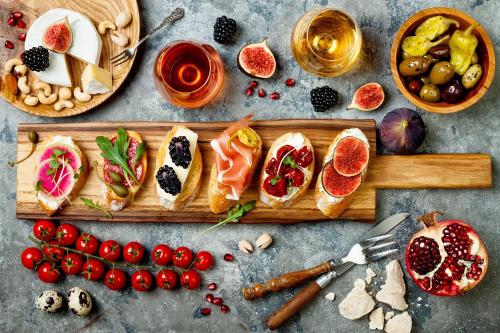 a table with a cutting board with food and fruit at The Castle Hotel in Amman