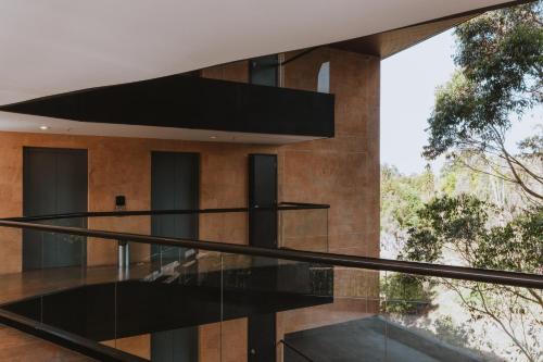 an external view of a building with glass stairs at Travelers Rio Verde Living Suites in Rionegro
