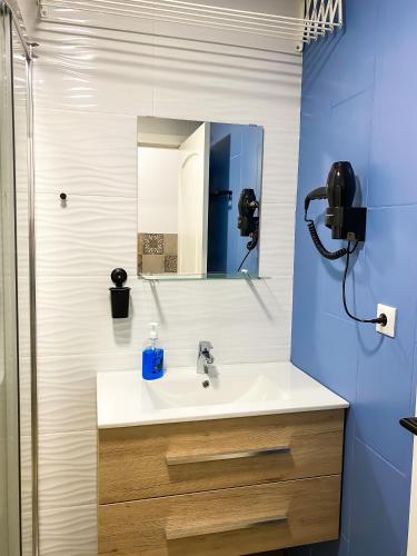 a bathroom with a sink and a mirror at Apartamentos Pueblo Mar in Calpe