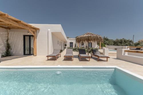 a villa with a swimming pool and a house at Golden Sand Villas with Private Pool in Vívlos