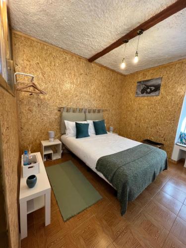 a bedroom with a large bed and two tables at Residencial Mira-Mar in Peniche