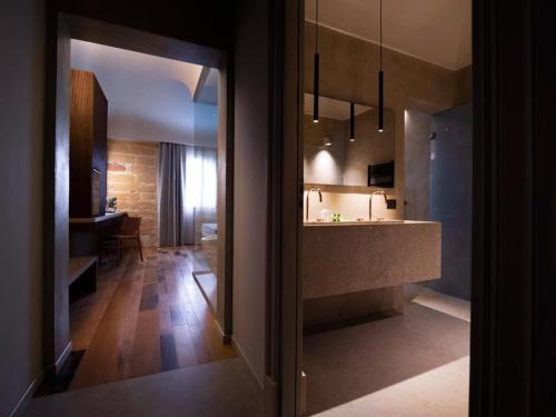 a kitchen with a counter and a dining room at Villa Favorita Hotel & Events in Marsala