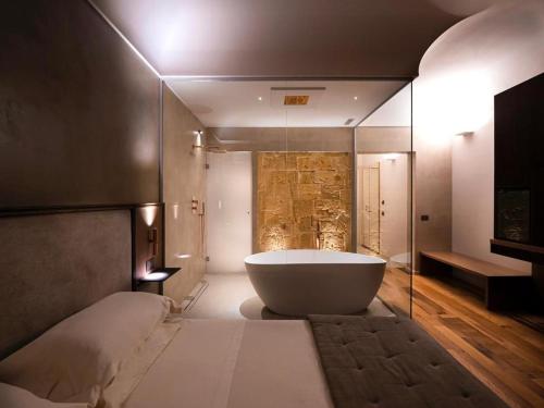 a bathroom with a large tub in a room at Villa Favorita Hotel & Events in Marsala