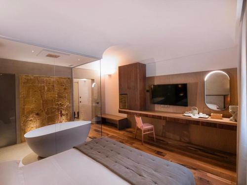 a large bathroom with a tub and a sink at Villa Favorita Hotel & Events in Marsala