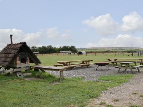 a group of picnic tables in a field at Lime Kiln in Blagdon