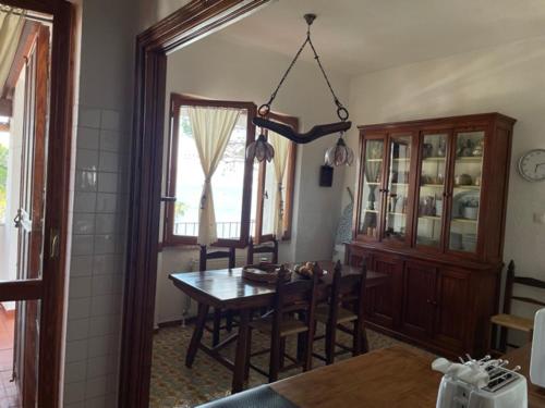 a kitchen with a table and a dining room at Villa Clelia al mare in Porto Pino