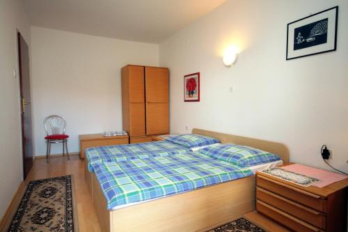 a bedroom with a bed and a desk and a chair at Apartment Selce 2379a in Selce