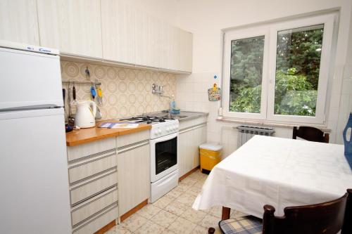 a kitchen with a table and a stove top oven at Apartment Selce 2379a in Selce