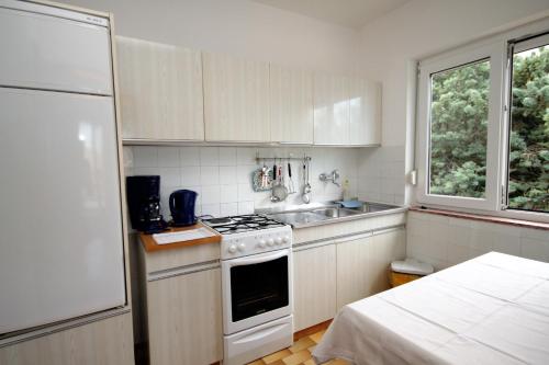 a small kitchen with a stove and a sink at Apartment Selce 2379b in Selce