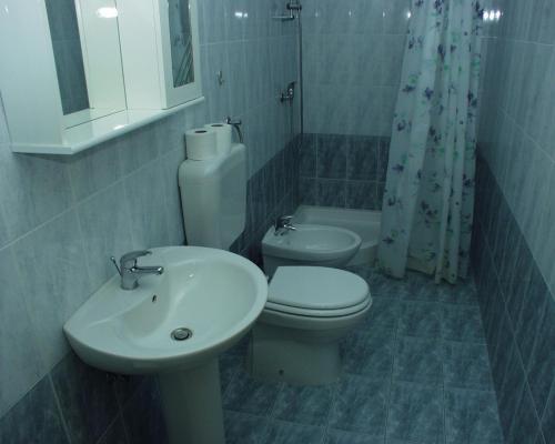 a bathroom with a sink and a toilet and a shower at Apartment Rabac 2323a in Rabac