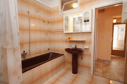 a bathroom with a sink and a bath tub at Apartment Rabac 2340a in Rabac