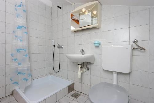 a bathroom with a toilet and a sink and a shower at Apartments and rooms with parking space Selce, Crikvenica - 2362 in Selce