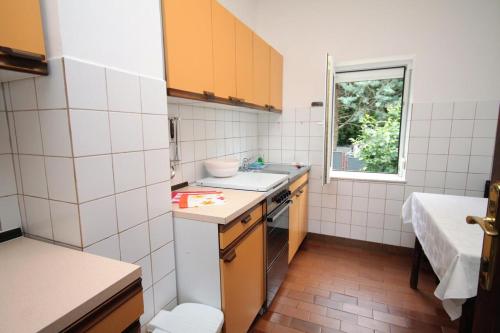 a small kitchen with a sink and a window at Apartments and rooms with parking space Selce, Crikvenica - 2379 in Selce