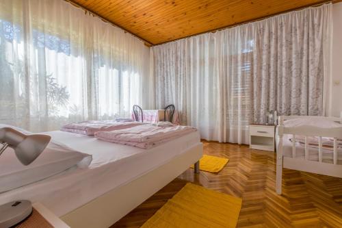 a bedroom with a bed and a large window at Apartment Selce 2381a in Selce