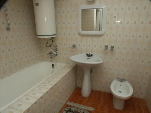 a bathroom with a sink and a tub and a toilet at Apartment Selce 2372c in Selce