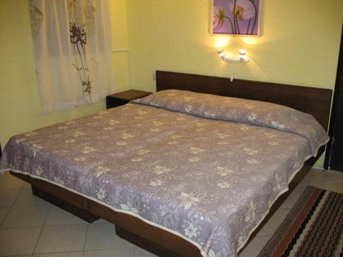 a bedroom with a bed with a purple comforter at Studio Novi Vinodolski 2382a in Novi Vinodolski