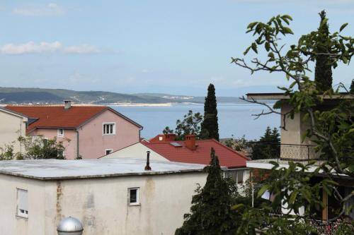 a view of a town with the ocean in the background at Triple Room Selce 2379d in Selce