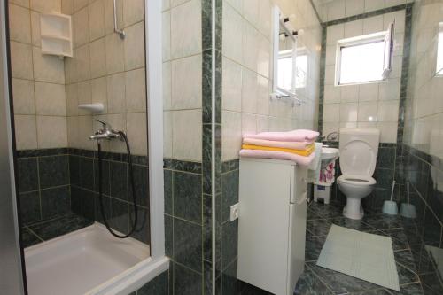 a bathroom with a shower and a toilet and a sink at Apartments by the sea Selce, Crikvenica - 2392 in Selce