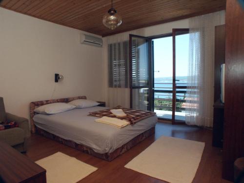 a bedroom with a bed with a view of the ocean at Apartments and rooms with parking space Dramalj, Crikvenica - 2386 in Dramalj