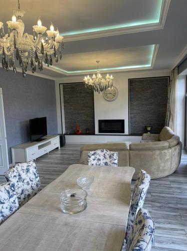 a living room with a table and a couch at Villa Qusar in Qusar