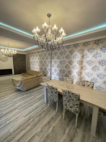 a living room with a table and a couch at Villa Qusar in Qusar