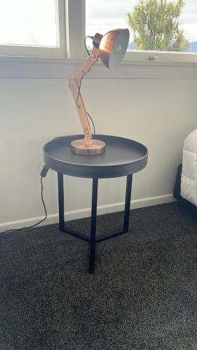 a lamp sitting on a table in a room at GLENALMOND Country Motels in Harihari