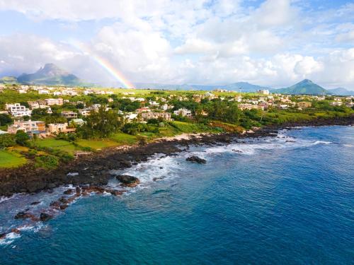 an aerial view of a beach with a rainbow at Villa Osiris in Flic-en-Flac