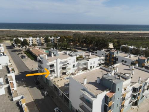 an aerial view of a building with the beach in the background at Casa Happiness, swimming pool, fast WiFi, parking in Lagos