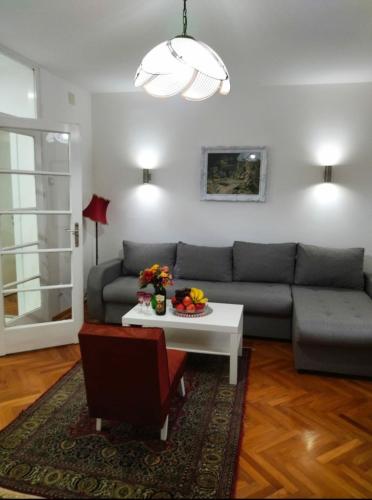 a living room with a couch and a table at Palace Luxury Apartments The Heart of Belgrade in Belgrade