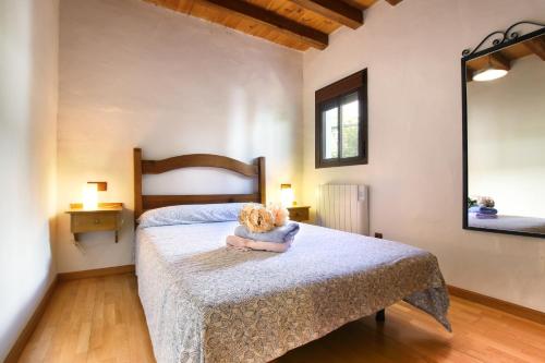 a teddy bear sitting on a bed in a bedroom at casa la parra in Jubrique