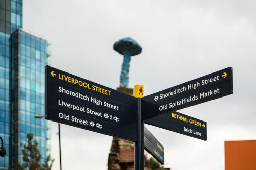 a street sign in front of a pole with street signs at Apex City Of London Hotel in London
