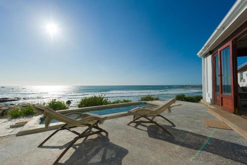 a statue of a bird sitting next to a swimming pool at The Oystercatchers Haven at Paternoster in Paternoster