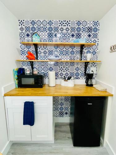 a kitchen with a counter with blue and white tiles at Our Lovely Nest, Free Parking & Wi-Fi in Miami