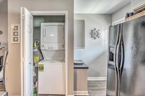 a kitchen with a refrigerator and a sink at Waterfront Ocean Isle Beach Condo with Balcony! in Ocean Isle Beach