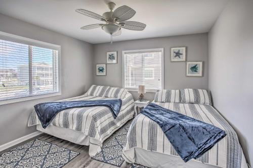 a bedroom with two beds and a ceiling fan at Waterfront Ocean Isle Beach Condo with Balcony! in Ocean Isle Beach