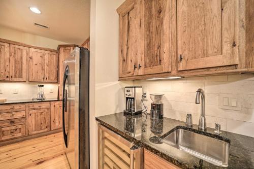a kitchen with wooden cabinets and a stainless steel refrigerator at Secluded Sapphire Chalet with Game Room and Decks in Sapphire