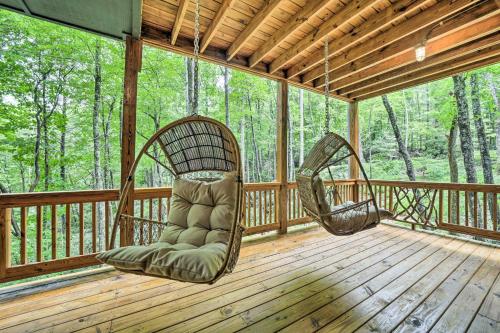 a porch with two chairs and a swing at Secluded Sapphire Chalet with Game Room and Decks in Sapphire